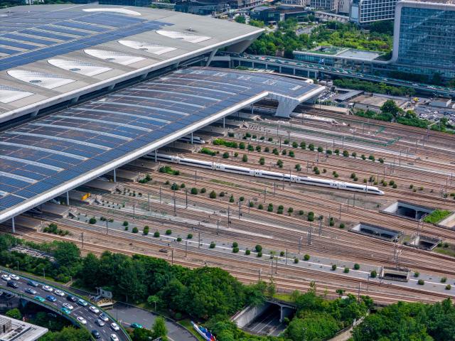 This aerial photo shows solar panels on the roof of a railway station in Hangzhou, eastern China's Zhejiang province on October 29, 2025. (Photo by AFP) / China OUT