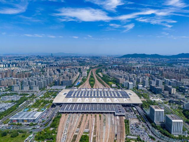This aerial photo shows solar panels on the roof of a railway station in Hangzhou, eastern China's Zhejiang province on October 29, 2025. (Photo by AFP) / China OUT