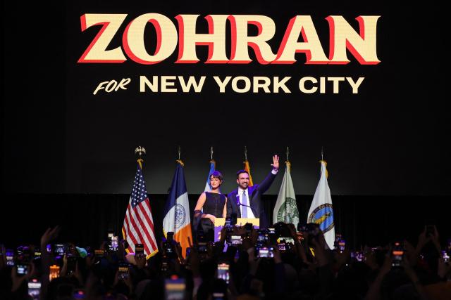New York City Mayoral candidate Zohran Mamdani (R) celebrates alongside his wife Rama Duwaji (L) during an election night event at the Brooklyn Paramount Theater in Brooklyn, New York on November 4, 2025. New Yorkers elected leftist Zohran Mamdani as their next mayor November 4, 2025 broadcasters projected, on a day of key local ballots across the country offering the first electoral judgement of Donald Trump's tumultuous second White House term. (Photo by ANGELA WEISS / AFP)