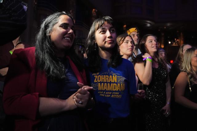 Supporters listen to New York City Mayoral candidate Zohran Mamdani speak during an election night event at the Brooklyn Paramount Theater in Brooklyn, New York on November 4, 2025. New Yorkers elected leftist Zohran Mamdani as their next mayor November 4, 2025 broadcasters projected, on a day of key local ballots across the country offering the first electoral judgement of Donald Trump's tumultuous second White House term. (Photo by Angelina Katsanis / AFP)