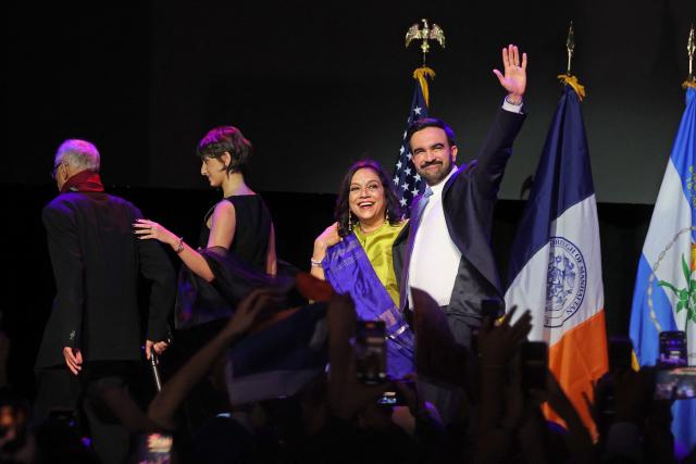 New York City Mayoral candidate Zohran Mamdani (R) celebrates alongside his mother Mira Nair (2nd R), his wife Rama Duwaji (2nd L), and his father Mahmood Mamdani (L)  during an election night event at the Brooklyn Paramount Theater in Brooklyn, New York on November 4, 2025. New Yorkers elected leftist Zohran Mamdani as their next mayor November 4, 2025 broadcasters projected, on a day of key local ballots across the country offering the first electoral judgement of Donald Trump's tumultuous second White House term. (Photo by ANGELA WEISS / AFP)