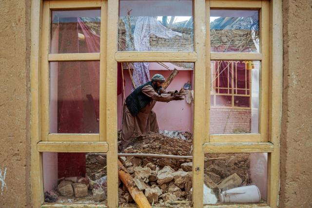 TOPSHOT - An Afghan man clears rubble from his damaged house, in the aftermath of an earthquake at a village in the Khulm district of Samangan province on November 4, 2025. An earthquake of 6.3-magnitude in northern Afghanistan has killed at least 27 people and injured nearly 1,000, the health ministry said on November 4, announcing the end of rescue operations. (Photo by AFP)