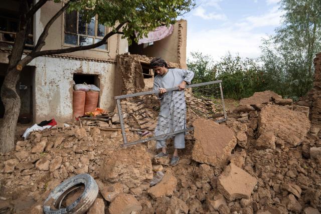 An Afghan man clears rubble from the courtyard of his damaged house, in the aftermath of an earthquake at a village in the Khulm district of Samangan province on November 4, 2025. An earthquake of 6.3-magnitude in northern Afghanistan has killed at least 27 people and injured nearly 1,000, the health ministry said on November 4, announcing the end of rescue operations. (Photo by AFP)
