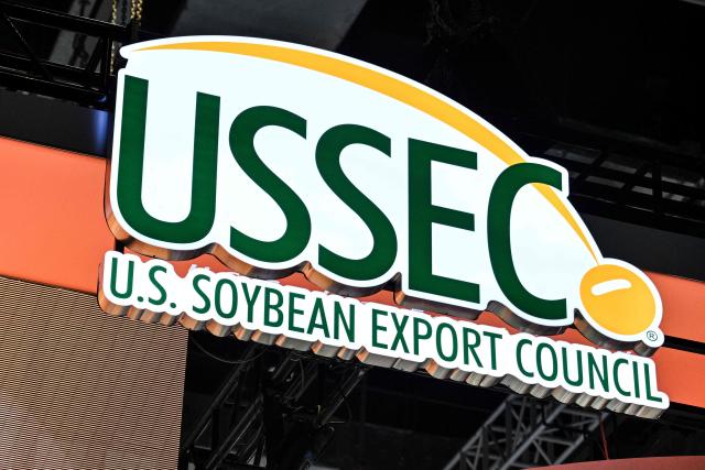 The logo of the US Soybean Export Council is seen at the US Soybean Export Council stand during the 8th China International Import Expo (CIIE) in Shanghai on November 5, 2025. China said on November 5, it would extend a suspension of additional tariffs on US goods for one year, making official an agreement reached in talks between presidents Xi Jinping and Donald Trump last week. (Photo by Hector RETAMAL / AFP)
