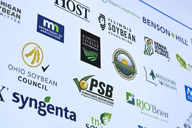 Soybean producer logos are seen at the US Soybean Export Council stand during the 8th China International Import Expo (CIIE) in Shanghai on November 5, 2025. China said on November 5, it would extend a suspension of additional tariffs on US goods for one year, making official an agreement reached in talks between presidents Xi Jinping and Donald Trump last week. (Photo by Hector RETAMAL / AFP)