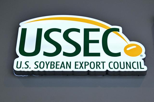 The logo of the US Soybean Export Council is seen at the US Soybean Export Council stand during the 8th China International Import Expo (CIIE) in Shanghai on November 5, 2025. China said on November 5, it would extend a suspension of additional tariffs on US goods for one year, making official an agreement reached in talks between presidents Xi Jinping and Donald Trump last week. (Photo by Hector RETAMAL / AFP)