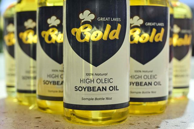 Bottles of soybean oil are seen at the US Soybean Export Council stand during the 8th China International Import Expo (CIIE) in Shanghai on November 5, 2025. China said on November 5, it would extend a suspension of additional tariffs on US goods for one year, making official an agreement reached in talks between presidents Xi Jinping and Donald Trump last week. (Photo by Hector RETAMAL / AFP)