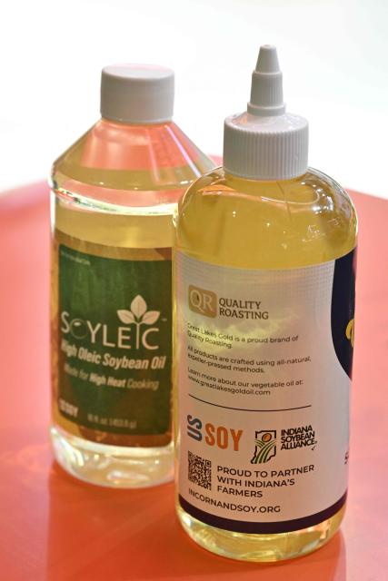 Bottles of soybean oil are seen at the US Soybean Export Council stand during the 8th China International Import Expo (CIIE) in Shanghai on November 5, 2025. China said on November 5, it would extend a suspension of additional tariffs on US goods for one year, making official an agreement reached in talks between presidents Xi Jinping and Donald Trump last week. (Photo by Hector RETAMAL / AFP)