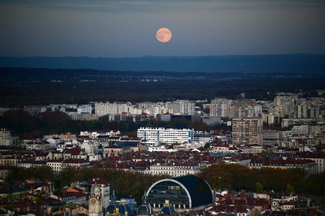 The full moon, known as Beaver Moon, rises over the city of Lyon, on November 5, 2025. (Photo by OLIVIER CHASSIGNOLE / AFP)