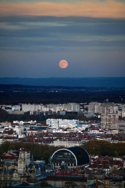 The full moon, known as Beaver Moon, rises over the city of Lyon, on November 5, 2025. (Photo by OLIVIER CHASSIGNOLE / AFP)