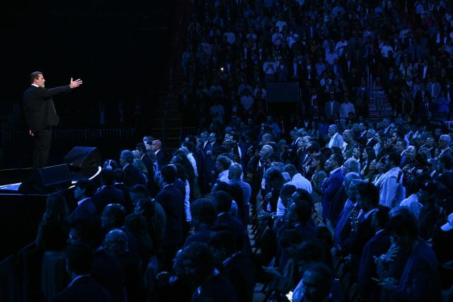 Motivational speaker, life coach, and author Tony Robbins (L) speaks at the American Business Forum at the Kaseya Center in Miami on November 5, 2025. (Photo by Brendan SMIALOWSKI / AFP)