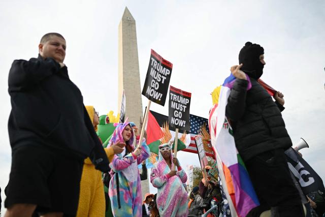 Demonstrators take part in a "Trump Must Go" protest on the National Mall in Washington, DC, on November 5, 2025, marking the first anniversary of Donald Trump’s election to a second term. (Photo by ANDREW CABALLERO-REYNOLDS / AFP)