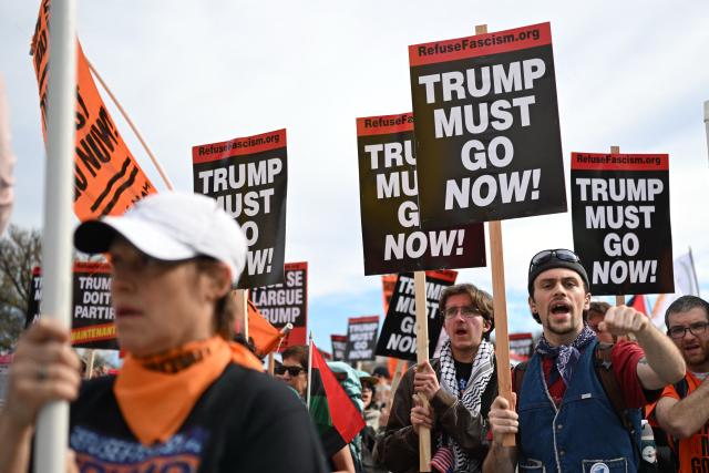 Demonstrators take part in a "Trump Must Go" protest on the National Mall in Washington, DC, on November 5, 2025, marking the first anniversary of Donald Trump’s election to a second term. (Photo by ANDREW CABALLERO-REYNOLDS / AFP)