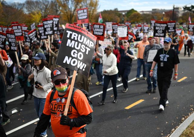 Demonstrators take part in a "Trump Must Go" protest near the National Mall in Washington, DC, on November 5, 2025, marking the first anniversary of Donald Trump’s election to a second term. (Photo by ANDREW CABALLERO-REYNOLDS / AFP)