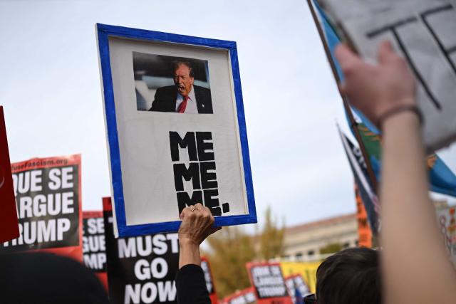 Demonstrators take part in a "Trump Must Go" protest near the National Mall in Washington, DC, on November 5, 2025, marking the first anniversary of Donald Trump’s election to a second term. (Photo by ANDREW CABALLERO-REYNOLDS / AFP)