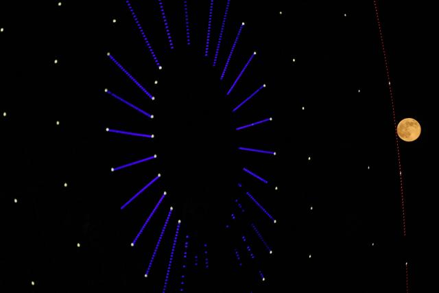 The super moon is pictured next to a turning wheel in the northern Syrian city of Idlib on November 5, 2025. (Photo by OMAR HAJ KADOUR / AFP)