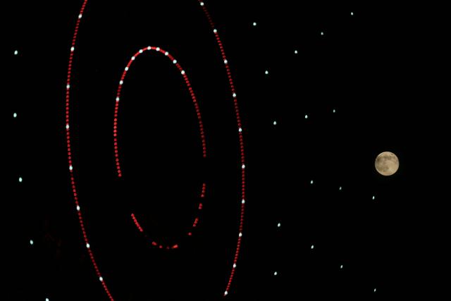 The super moon is pictured next to a turning wheel in the northern Syrian city of Idlib on November 5, 2025. (Photo by OMAR HAJ KADOUR / AFP)