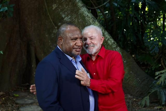 Brazil's President Luiz Inacio Lula da Silva (R) and Papua New Guinea's Prime Minister James Marape (L) greet during a meeting in Belem, Para State, Brazil, on November 5, 2025. Lula da Silva is preparing to hots the COP30 UN climate summit next November 10 to 21, in Belem. (Photo by Tarso Sarraf / AFP)