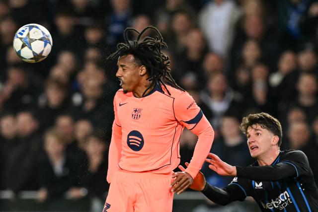 Barcelona's French defender #23 Jules Kounde heads the ball as Club Brugge's Greek forward #08 Christos Tzolis (R) looks on during the UEFA Champions League league phase day 4 football match between Club Brugge and FC Barcelona at Jan Breydelstadion stadium, in Bruges, on November 5, 2025. (Photo by NICOLAS TUCAT / AFP)