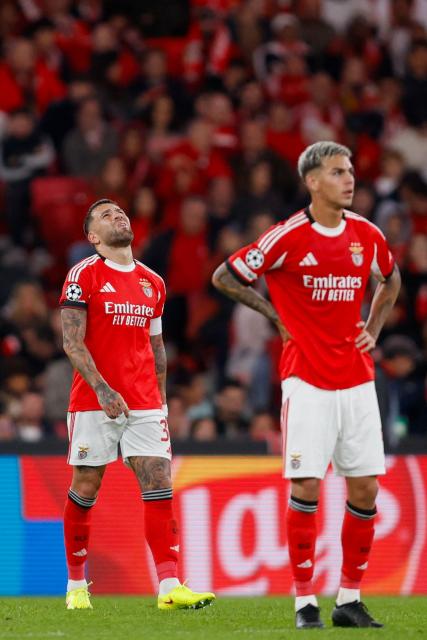SL Benfica's Argentine defender #30 Nicolas Otamendi (L) and SL Benfica's Argentine midfielder #05 Enzo Barrenechea react after Bayer Leverkusen scored their first goal during the UEFA Champions League league phase day 4 football match between SL Benfica and Bayer Leverkusen at Estadio da Luz in Lisbon on November 5, 2025. (Photo by FILIPE AMORIM / AFP)