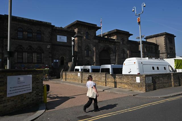 (FILES) A pedestrian passes the stone walls of HM Prison Wandsworth in the late summer sunshine in south London on September 7, 2023. British police said on November 5, 2025, they had launched a manhunt for two prisoners, including an Algerian, mistakenly released from Wandsworth jail, angering parliamentarians at the latest mix-up committed by the UK's beleaguered prison system.  London's Metropolitan Police force said in a statement it was looking for 24-year-old Brahim Kaddour Cherif, a registered sex offender, after he was released in error a week ago. Separately, police in Surrey, southwest of  London, said that Wandsworth prison had on Monday mistakenly released another man convicted of multiple fraud offences. (Photo by JUSTIN TALLIS / AFP)