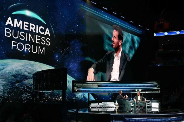 Argentine soccer player Lionel Messi (R) and Miami Mayor Francis Suarez (L) speak at the American Business Forum at the Kaseya Center in Miami on November 5, 2025. (Photo by CHANDAN KHANNA / AFP)