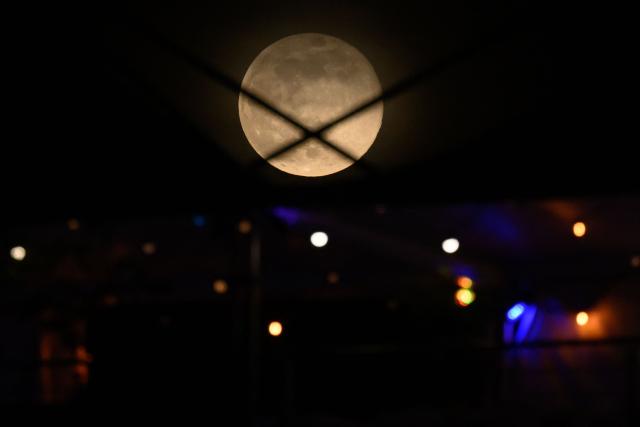 November's full moon, also known as Beaver Moon, rises over Fort-de-France in the French overseas island of Martinique, on November 5, 2025. (Photo by Loic VENANCE / AFP)