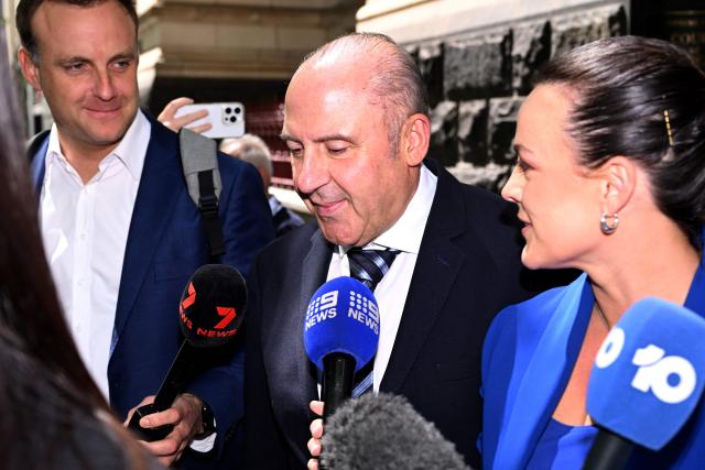 Tony Mokbel (C), one of the key figures in Melbourne's years-long gangland war, walks from the Victoria Supreme Court of Appeal in Melbourne on November 6, 2025. Mokbel has avoided any more jail time over a decades-old drug trafficking charge, a court ruled Thursday. (Photo by William WEST / AFP)