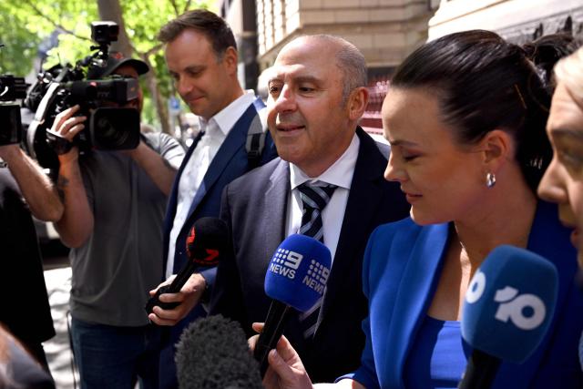 Tony Mokbel (C), one of the key figures in Melbourne's years-long gangland war, walks from the Victoria Supreme Court of Appeal in Melbourne on November 6, 2025. Mokbel has avoided any more jail time over a decades-old drug trafficking charge, a court ruled Thursday. (Photo by William WEST / AFP)
