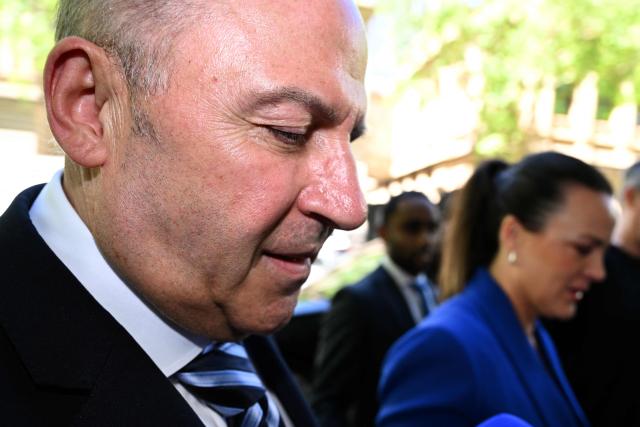 Tony Mokbel (L) -- one of the key figures in Melbourne's years-long gangland war -- walks from the Victoria Supreme Court of Appeal in Melbourne on November 6, 2025. Mokbel has avoided any more jail time over a decades-old drug trafficking charge, a court ruled Thursday. (Photo by William WEST / AFP)