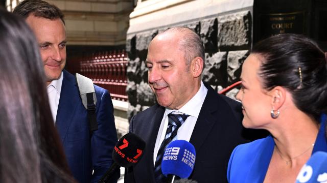 Tony Mokbel (C), one of the key figures in Melbourne's years-long gangland war, walks from the Victoria Supreme Court of Appeal in Melbourne on November 6, 2025. Mokbel has avoided any more jail time over a decades-old drug trafficking charge, a court ruled Thursday. (Photo by William WEST / AFP)