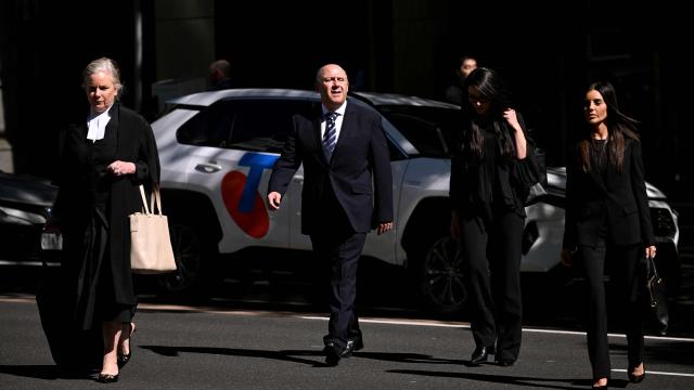 Tony Mokbel (C), one of the key figures in Melbourne's years-long gangland war, walks from the Victoria Supreme Court of Appeal in Melbourne on November 6, 2025. Mokbel has avoided any more jail time over a decades-old drug trafficking charge, a court ruled Thursday. (Photo by William WEST / AFP)