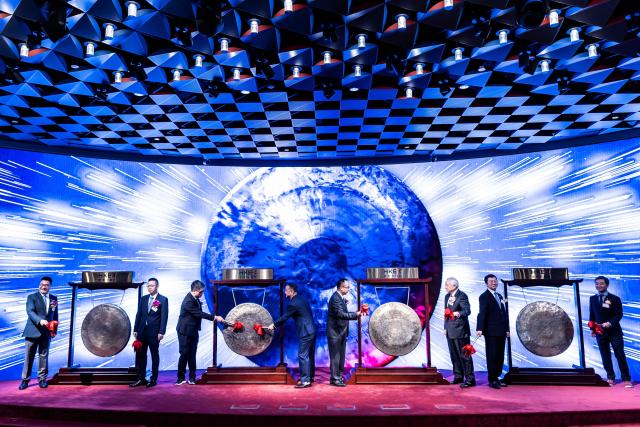 People attend the initial public offering (IPO) launch of Pony.AI and WeRide at the Hong Kong Stock Exchange on November 6, 2025. Shares in Chinese self-driving start-ups Pony.AI and WeRide falls on their first listing day in Hong Kong, as experts warns China has not fully ready to deploy a mass rollout of robotaxis due to regulatory changes. (Photo by ISAAC LAWRENCE / AFP)