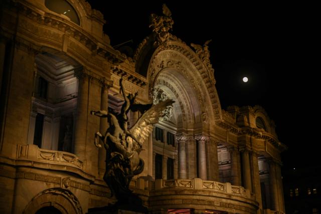 The full moon, known as the “Beaver Moon,” is seen rising next to the facade of the Palace of Fine Arts in Mexico City on November 5, 2025. (Photo by Yuri CORTEZ / AFP)