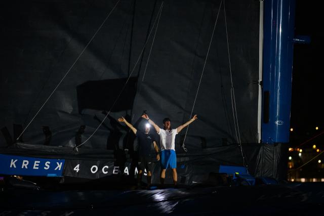 "SVR-LAZARTIGUE" ULTIM class multihull French skippers Franck Cammas (L) and Tom Laperche, celebrate while crossing the finish line to win the 17th edition of the Transat Cafe L'Or, off the shores of Fort-de-France, in the French overseas island of Martinique on November 5, 2025. Four open classes will take part in the race: IMOCA, Ocean Fifty, ULTIM and Class40. The Transat Cafe L'Or is a duo sailing race from Le Havre to Fort-de-France, in the French Caribbean island of Martinique. (Photo by Loic VENANCE / AFP)