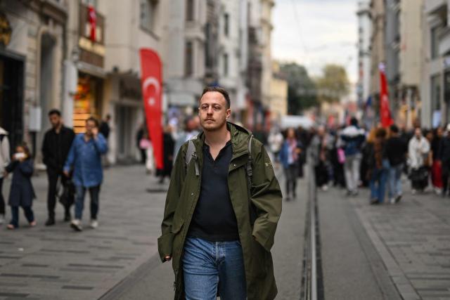 Director of SPoD NGO Ogulcan Yediveren poses in a street of Istanbul on October 28, 2025. "If this law passes, it will threaten our very existence," sighs Florence while making last-minute hair and makeup adjustments before taking to the stage at one of Istanbul's LGBTQ nightclubs. At issue are proposed changes to the penal code made by Turkey's conservative Islamo-centric government which would allow for the prosecution of anyone who identifies as gay, bisexual or transgender by criminalising any behaviour deemed "contrary to biological sex and general morality". (Photo by Yasin AKGUL / AFP)