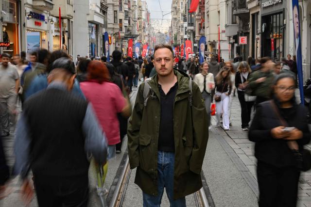 Director of SPoD NGO Ogulcan Yediveren poses in a street of Istanbul on October 28, 2025. "If this law passes, it will threaten our very existence," sighs Florence while making last-minute hair and makeup adjustments before taking to the stage at one of Istanbul's LGBTQ nightclubs. At issue are proposed changes to the penal code made by Turkey's conservative Islamo-centric government which would allow for the prosecution of anyone who identifies as gay, bisexual or transgender by criminalising any behaviour deemed "contrary to biological sex and general morality". (Photo by Yasin AKGUL / AFP)