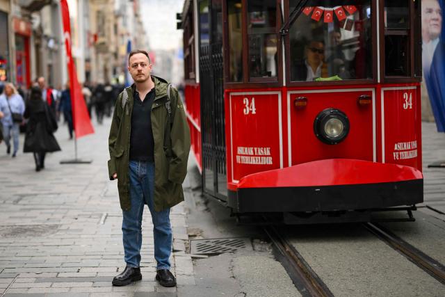Director of SPoD NGO Ogulcan Yediveren poses in a street of Istanbul on October 28, 2025. "If this law passes, it will threaten our very existence," sighs Florence while making last-minute hair and makeup adjustments before taking to the stage at one of Istanbul's LGBTQ nightclubs. At issue are proposed changes to the penal code made by Turkey's conservative Islamo-centric government which would allow for the prosecution of anyone who identifies as gay, bisexual or transgender by criminalising any behaviour deemed "contrary to biological sex and general morality". (Photo by Yasin AKGUL / AFP)