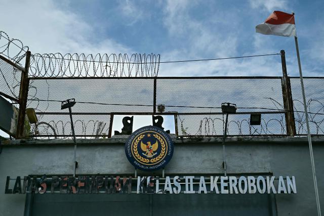 The Indonesia national flag flutters in the wind above an entrance to the Kerobokan Prison, where British grandmother Lindsay Sandiford is currently being held on death row, in Badung regency on the resort island of Bali on November 6, 2025. Indonesia signed an agreement on October 21 to repatriate two British nationals, including Sandiford, a seriously ill grandmother on death row for more than a decade on drug charges, a minister said. (Photo by Juni KRISWANTO / AFP)