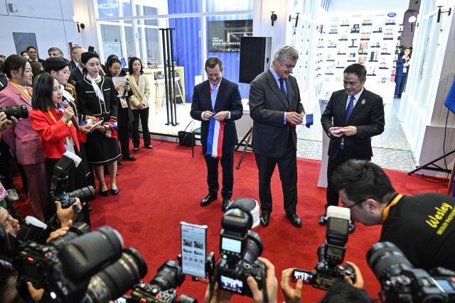 French Ambassador to China Bertrand Lortholary (L)? Deputy Minister for Foreign Trade  Nicolas Forissier (C) and deputy director-general of the CIIE Bureau Wu Zhengping (R) attend the inauguration of the pavillion of France during the 8th International Import Expo (CIIE) in Shanghai on November 6, 2025. (Photo by Hector RETAMAL / AFP)