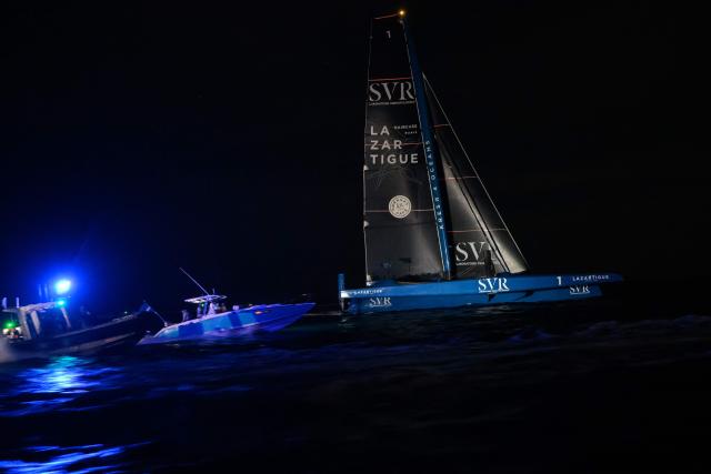 "SVR-LAZARTIGUE" ULTIM class multihull French skippers Franck Cammas and Tom Laperche, sail before to cross the finish line to win the 17th edition of the Transat Cafe L'Or, off the shores of Fort-de-France, in the French overseas island of Martinique on November 5, 2025. Four open classes will take part in the race: IMOCA, Ocean Fifty, ULTIM and Class40. The Transat Cafe L'Or is a duo sailing race from Le Havre to Fort-de-France, in the French Caribbean island of Martinique. (Photo by Loic VENANCE / AFP)