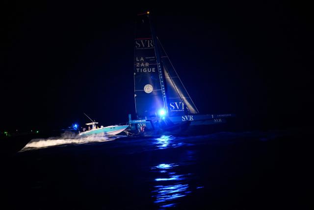 "SVR-LAZARTIGUE" ULTIM class multihull French skippers Franck Cammas and Tom Laperche, sail before to cross the finish line to win the 17th edition of the Transat Cafe L'Or, off the shores of Fort-de-France, in the French overseas island of Martinique on November 5, 2025. Four open classes will take part in the race: IMOCA, Ocean Fifty, ULTIM and Class40. The Transat Cafe L'Or is a duo sailing race from Le Havre to Fort-de-France, in the French Caribbean island of Martinique. (Photo by Loic VENANCE / AFP)