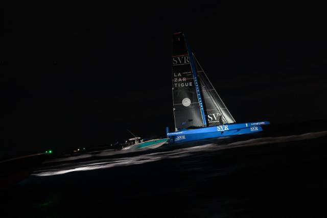 "SVR-LAZARTIGUE" ULTIM class multihull French skippers Franck Cammas and Tom Laperche, sail before to cross the finish line to win the 17th edition of the Transat Cafe L'Or, off the shores of Fort-de-France, in the French overseas island of Martinique on November 5, 2025. Four open classes will take part in the race: IMOCA, Ocean Fifty, ULTIM and Class40. The Transat Cafe L'Or is a duo sailing race from Le Havre to Fort-de-France, in the French Caribbean island of Martinique. (Photo by Loic VENANCE / AFP)