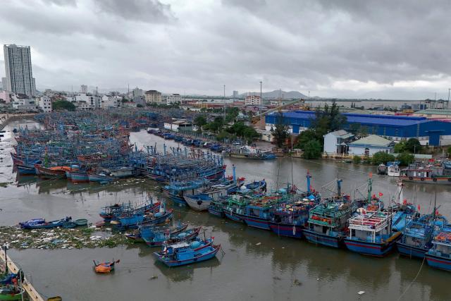 An aerial photo shows dark clouds over Quy Nhon fishing port as fishermen prepare vessels for the impact of Typhoon Kalmaegi in Gia Lai province in central Vietnam on November 6, 2025. The typhoon is forecast to make landfall in central Vietnam late on November 6, bringing waves as high as eight metres (26 feet) and powerful storm surges, according to the national weather bureau. (Photo by Nhac NGUYEN / AFP)