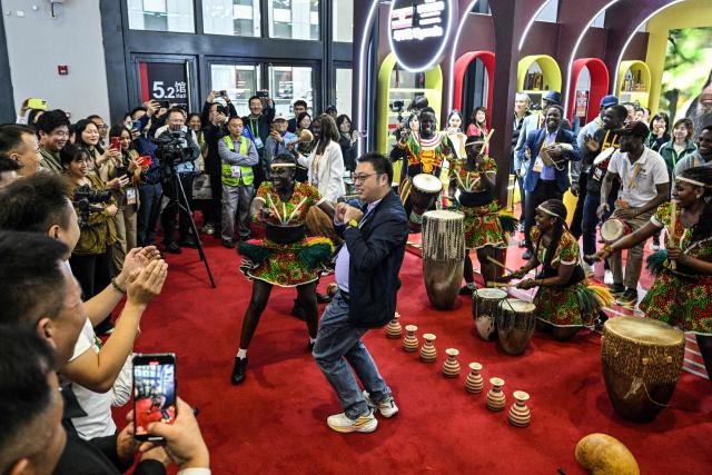 A group perform at the Uganda stand during the 8th International Import Expo (CIIE) in Shanghai on November 6, 2025. (Photo by Hector RETAMAL / AFP)
