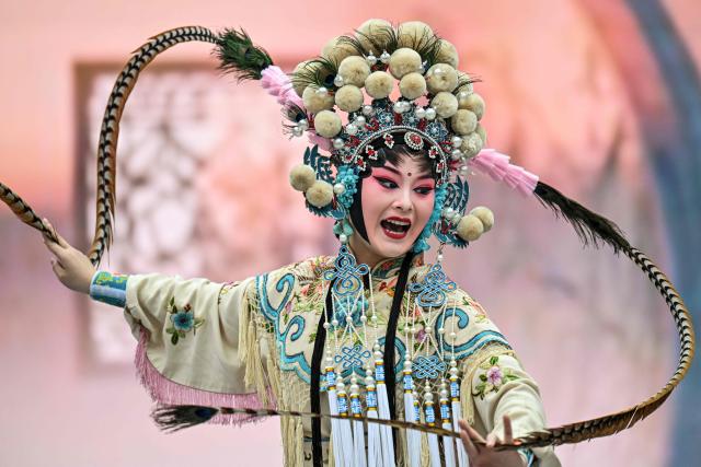 An actress performs in a Chinese Opera during the 8th International Import Expo (CIIE) in Shanghai on November 6, 2025. (Photo by Hector RETAMAL / AFP)