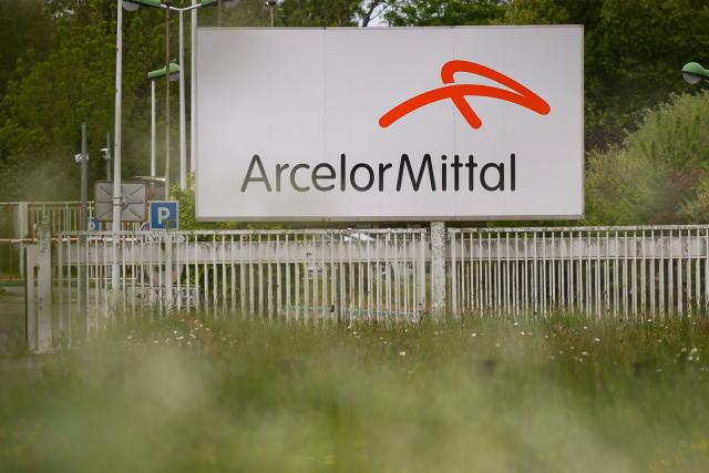 (FILES) This photograph shows a sign displaying the Arcelor Mital logo at the entrance to the Indre site, western France on April 24, 2025. Steel giant ArcelorMittal posted a net profit of $377 million (+31%) in the third quarter, and on November 6, 2025, called for "rapid approval" of the steel plan presented by the European Commission, which it said would allow "investment with confidence in the future". (Photo by Loic VENANCE / AFP)
