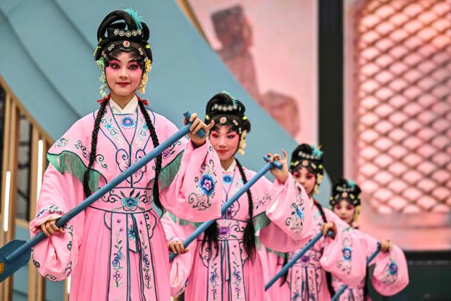 Actresses perform in Chinese Opera during the 8th International Import Expo (CIIE) in Shanghai on November 6, 2025. (Photo by Hector RETAMAL / AFP)