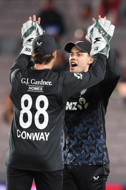 New Zealand’s Mark Chapman and wicket keeper Devon Conway (L) celebrate the wicket of West Indies' Rovman Powell during the second Twenty20 international cricket match between New Zealand and West Indies played at Eden Park in Auckland on November 6, 2025. (Photo by Michael Bradley / AFP)