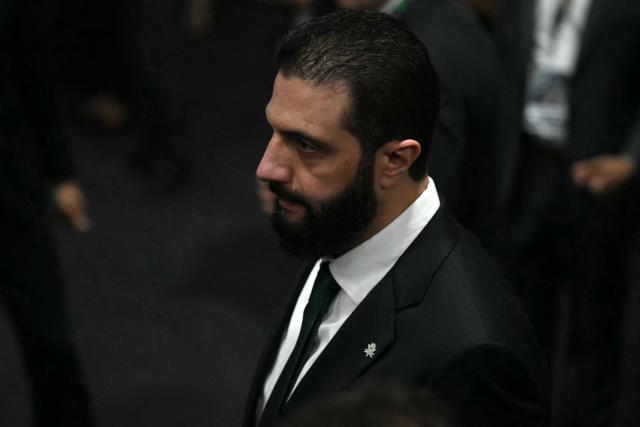 Syria's President Ahmad Al Sharaa walks on arrival at the General Plenary of Leaders in the framework of the COP30 UN Climate Change Conference in Belem, Para State, Brazil, on November 6, 2025. (Photo by Mauro PIMENTEL / AFP)